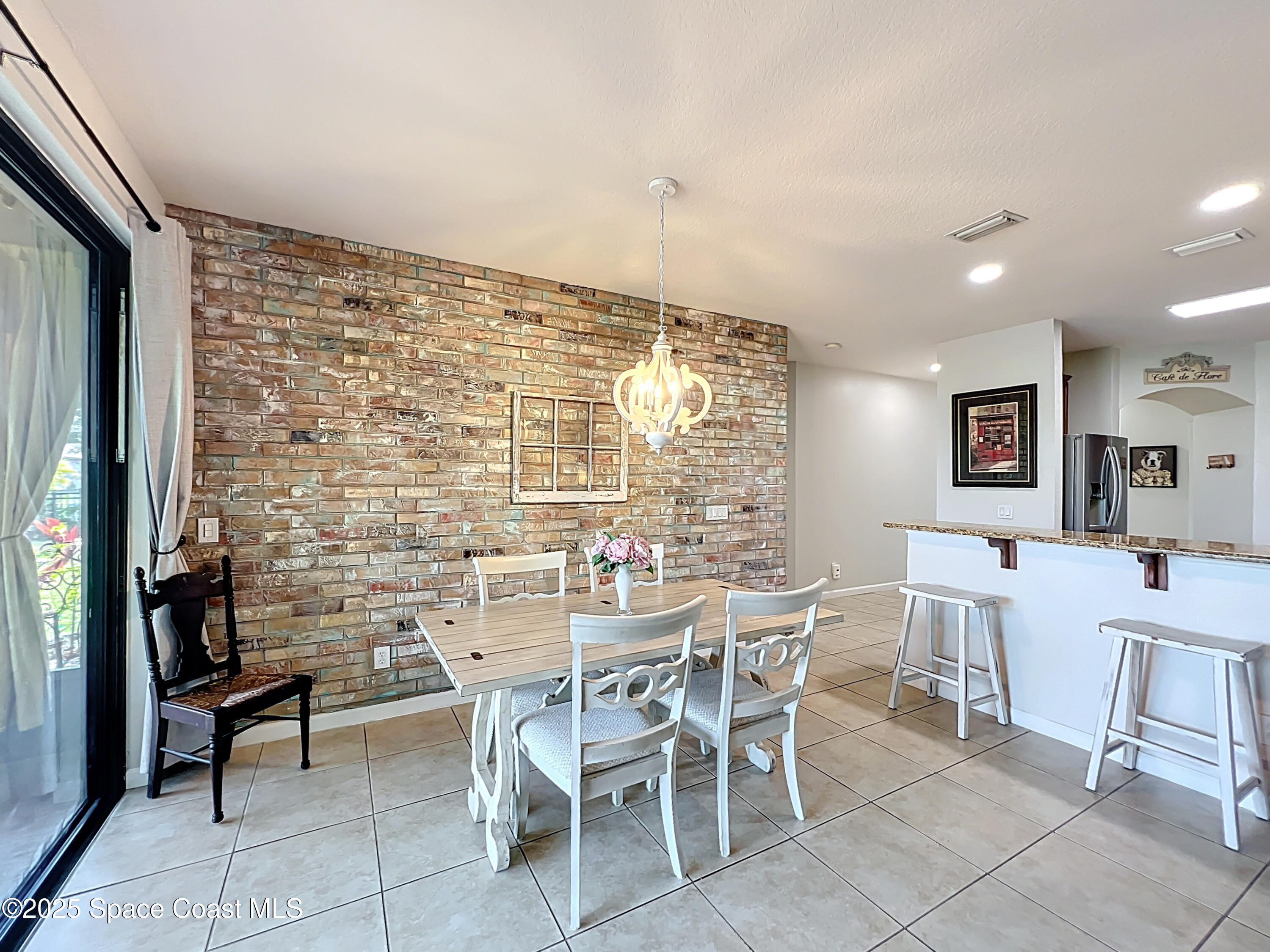 1110 Bolle Circle Rockledge, FL 32955 - Photo 14 of 39 a dining room with a wooden table and chairs
