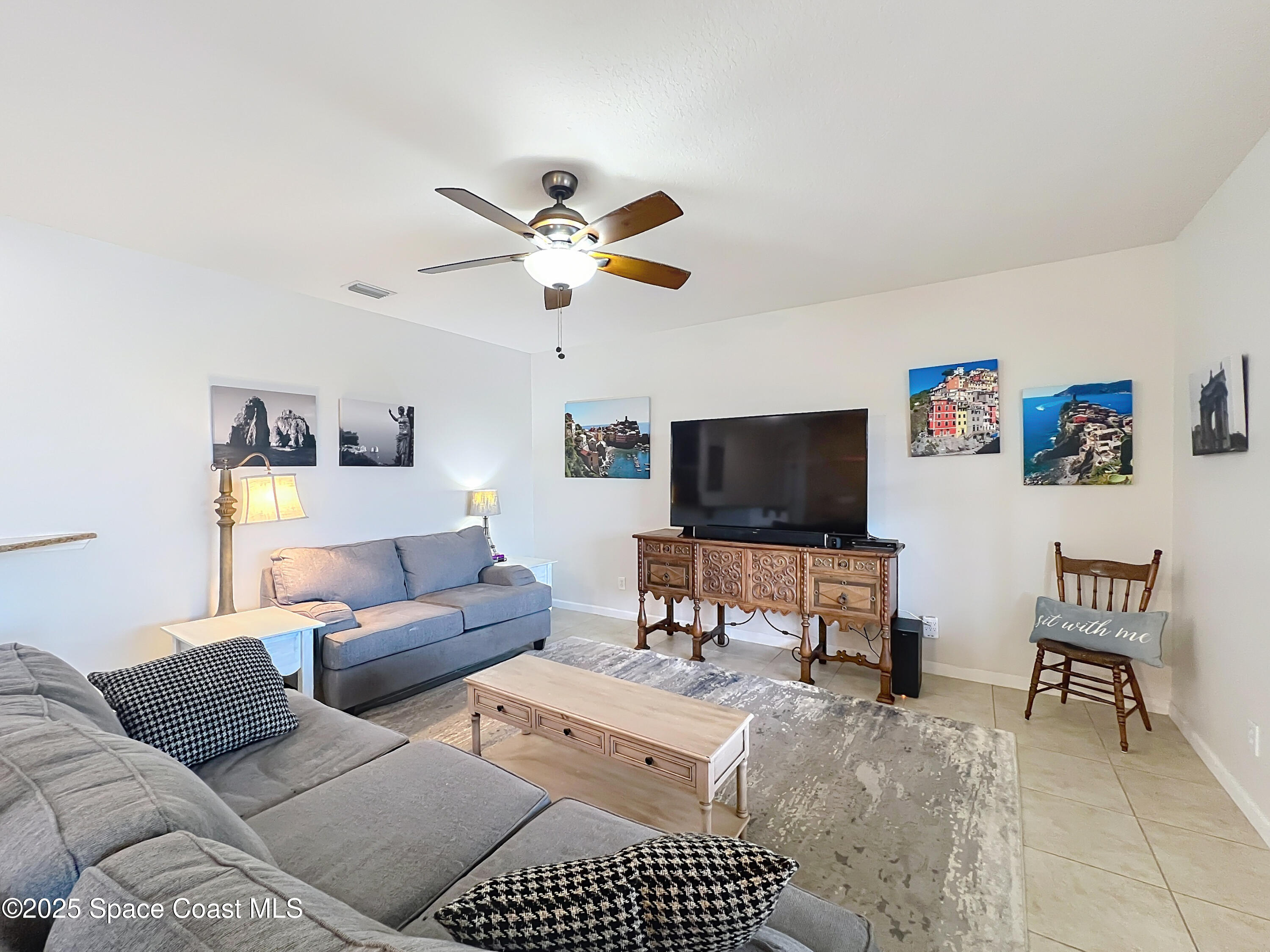 1110 Bolle Circle Rockledge, FL 32955 - Photo 15 of 39 a living room with furniture and a flat screen tv