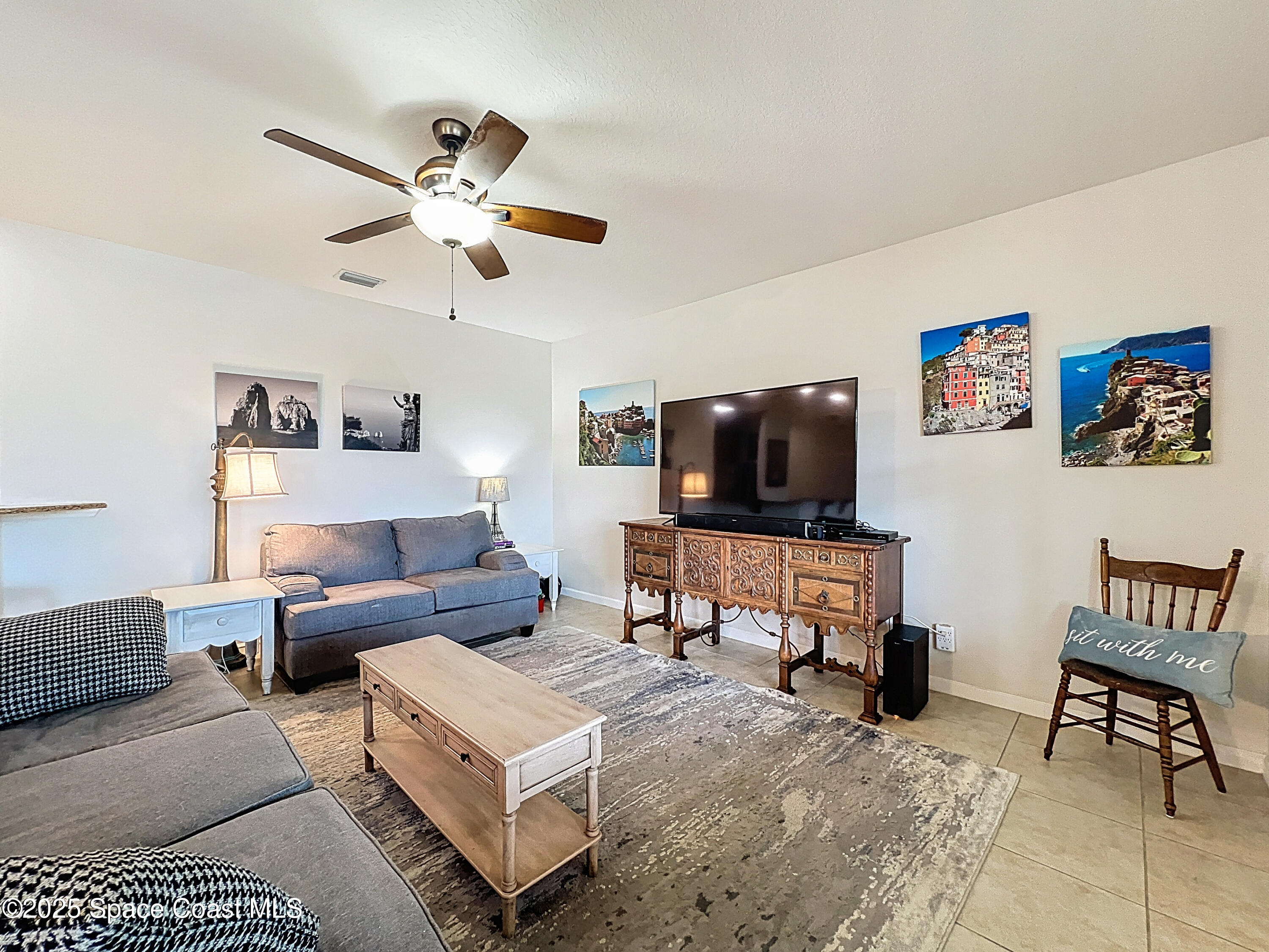 1110 Bolle Circle Rockledge, FL 32955 - Photo 18 of 39 a living room with furniture and a flat screen tv
