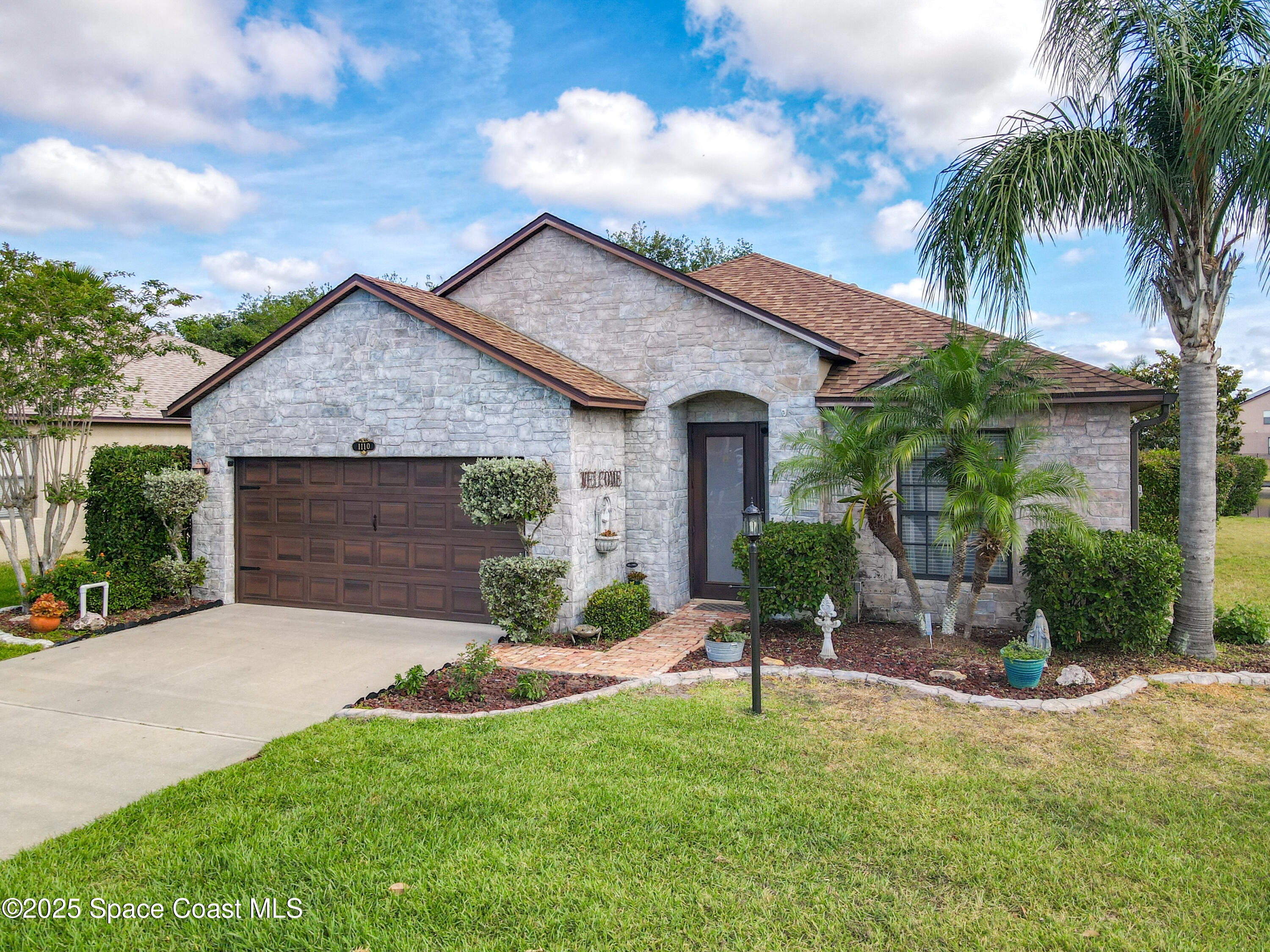 1110 Bolle Circle Rockledge, FL 32955 - Photo 2 of 39 a front view of a house with a yard and garage