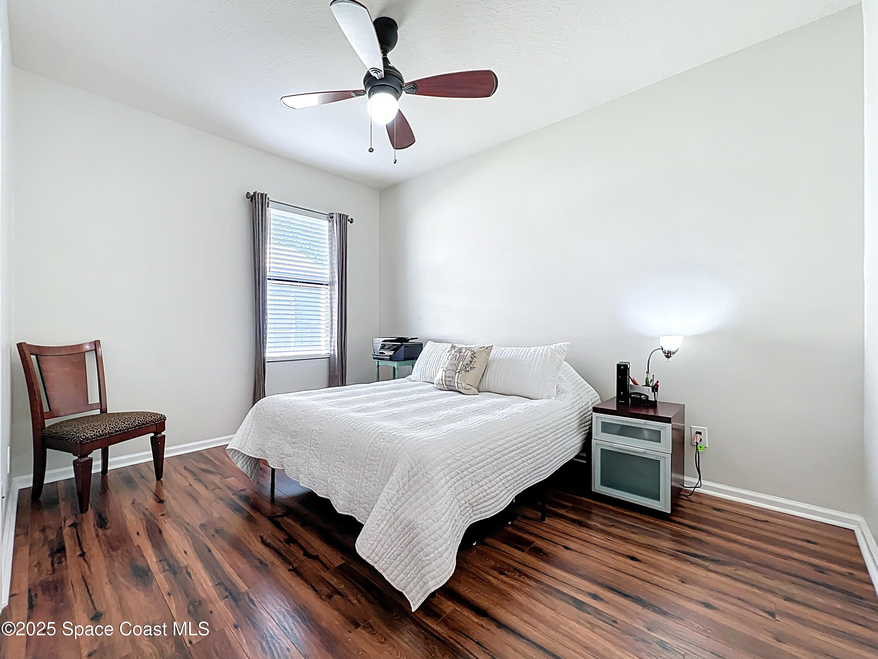 1110 Bolle Circle Rockledge, FL 32955 - Photo 21 of 39 a bedroom with a bed and a chair