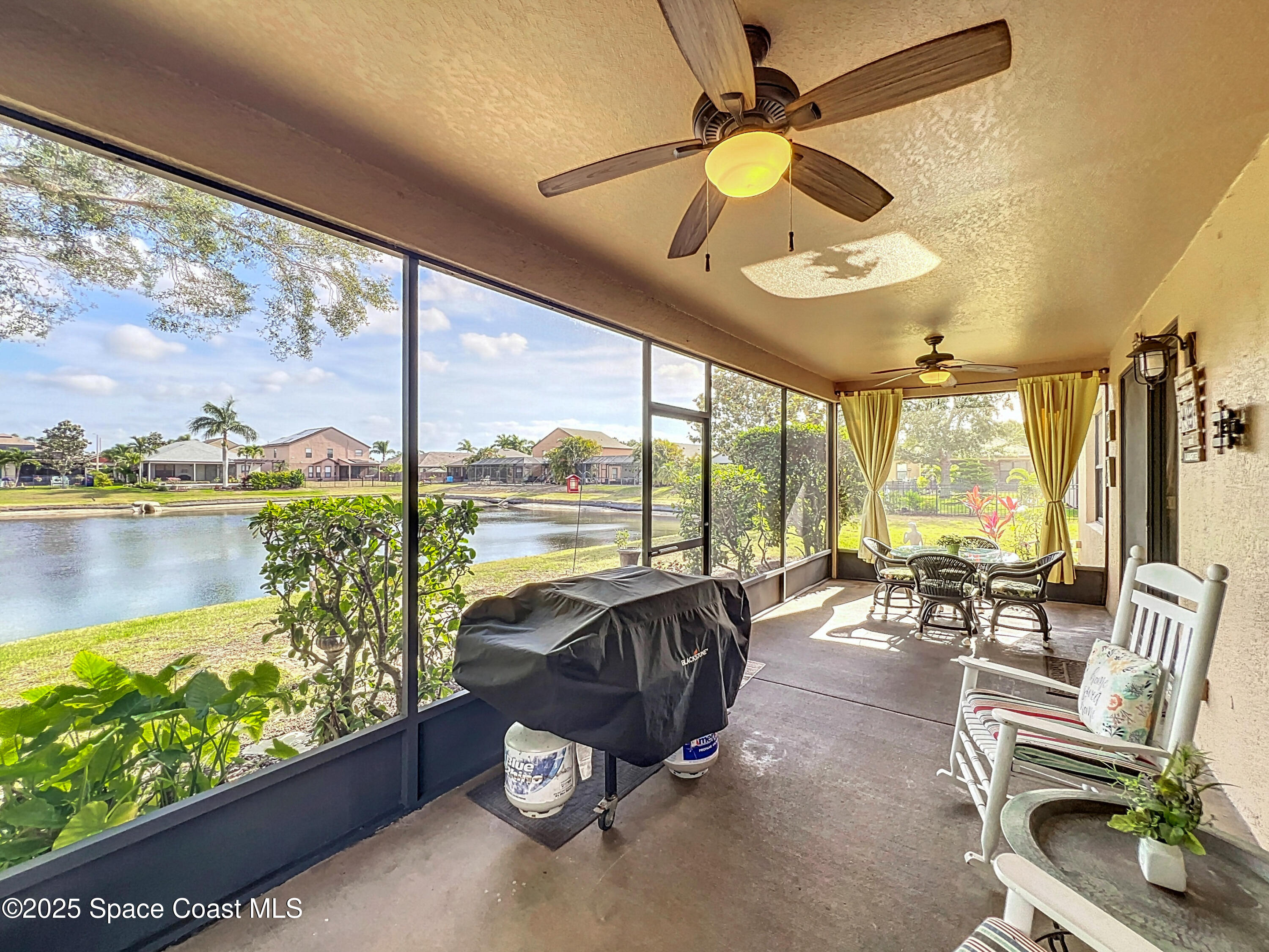1110 Bolle Circle Rockledge, FL 32955 - Photo 30 of 39 a living room with patio furniture and a large window