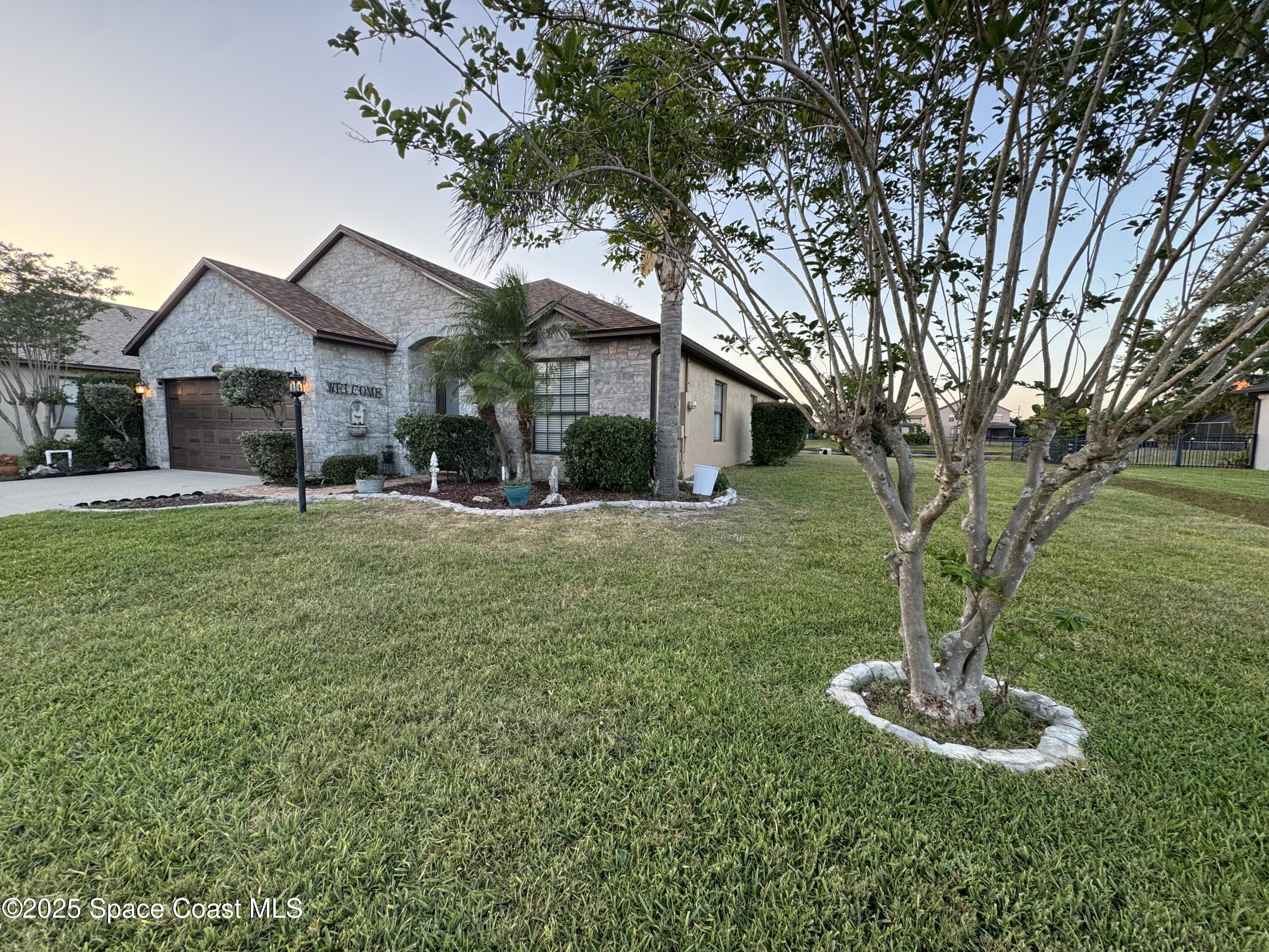 1110 Bolle Circle Rockledge, FL 32955 - Photo 36 of 39 a front view of a house with a yard