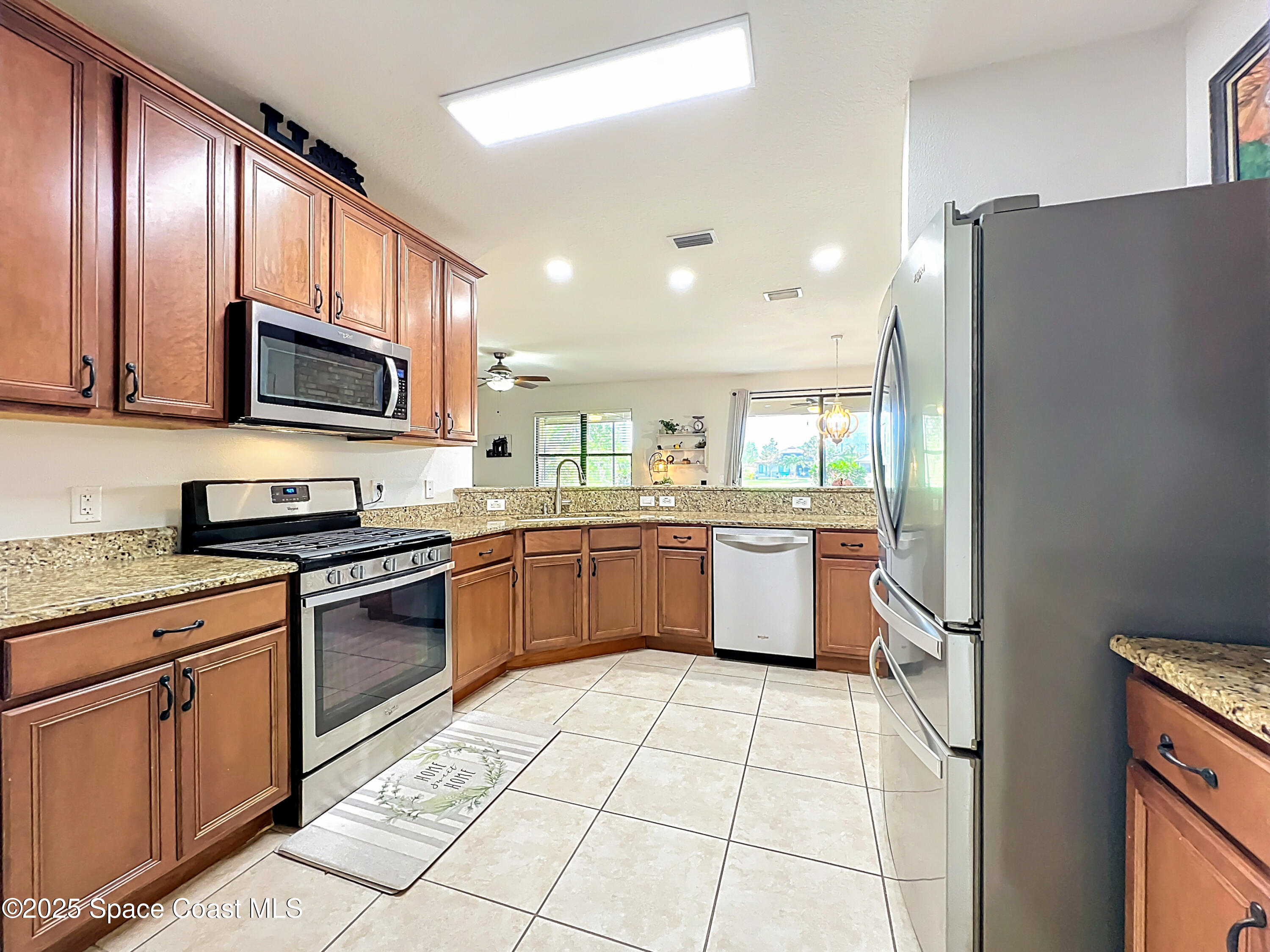 1110 Bolle Circle Rockledge, FL 32955 - Photo 8 of 39 a kitchen with stainless steel appliances granite countertop a refrigerator a stove a sink and a microwave