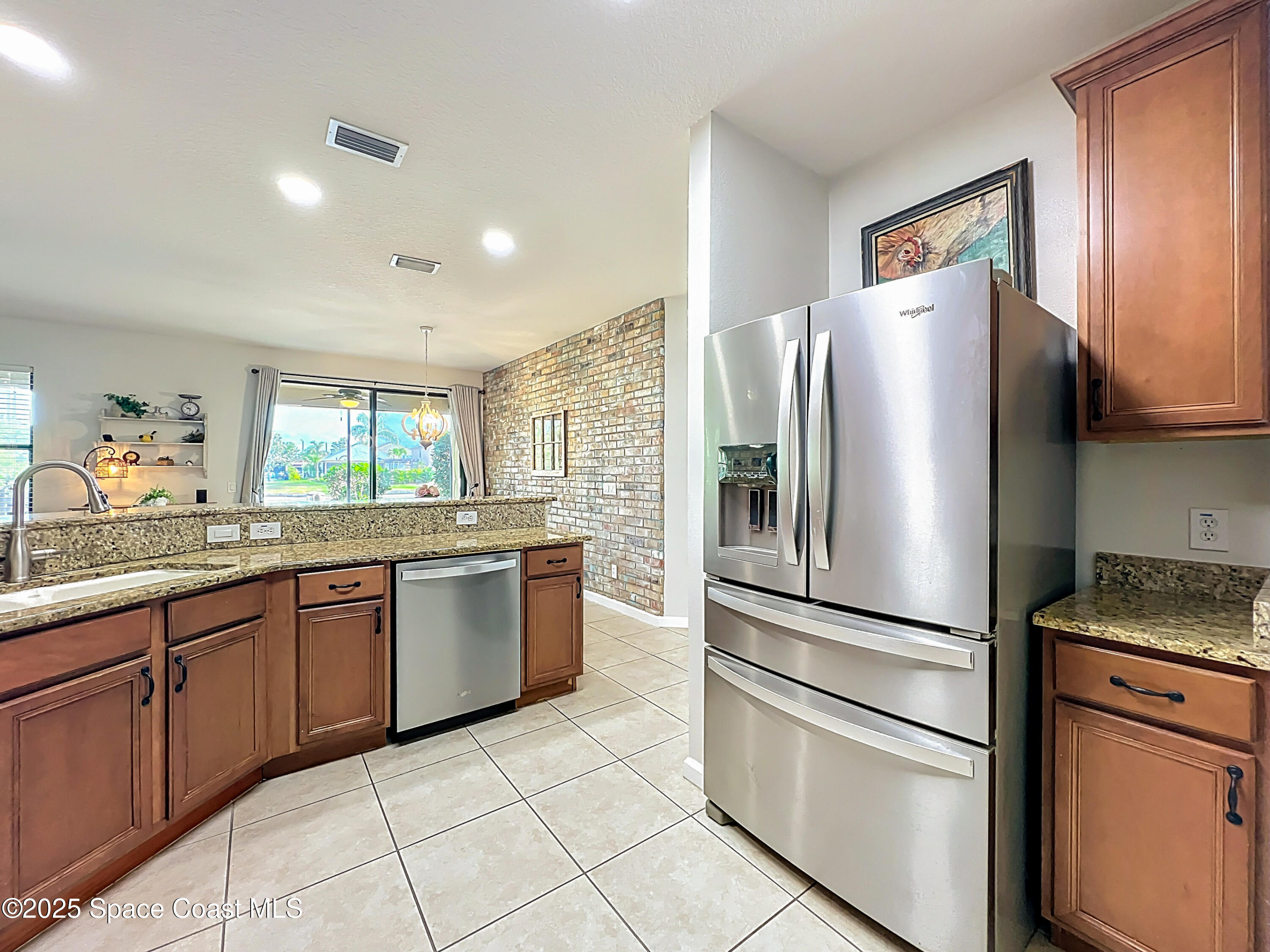 1110 Bolle Circle Rockledge, FL 32955 - Photo 9 of 39 a kitchen with granite countertop stainless steel appliances a refrigerator sink and microwave
