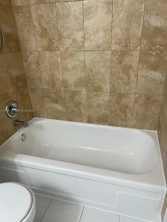 a bathroom with a bathtub and toilet
