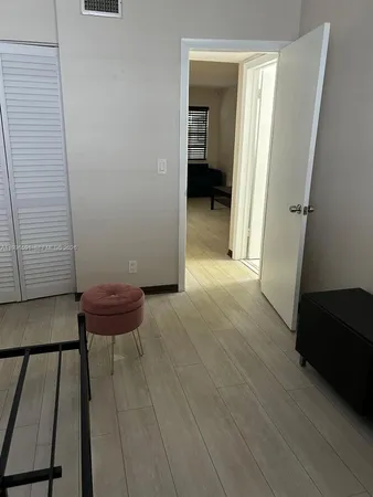 a view of a room with wooden floor and furniture