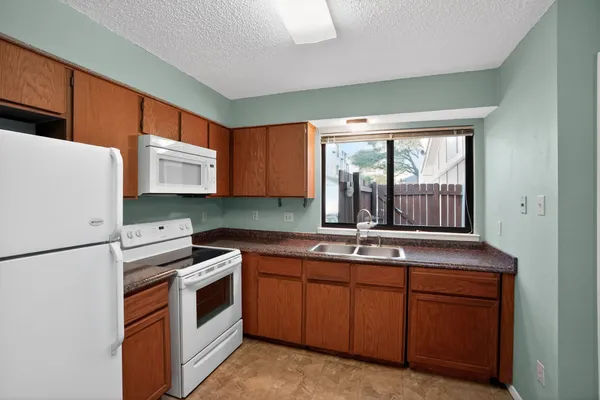 a kitchen with sink and cabinets