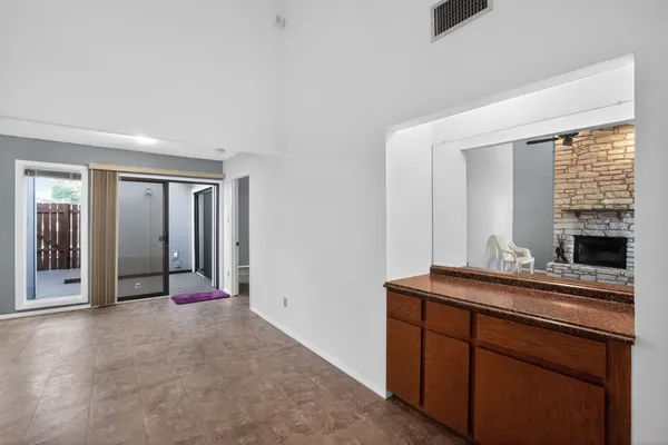 a kitchen with a refrigerator sink and cabinets
