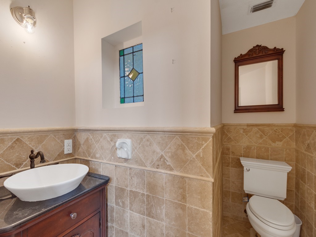 167 Deer Run Road Palm Bay, FL 32909 - Photo 10 of 35 a bathroom with a toilet a sink and mirror