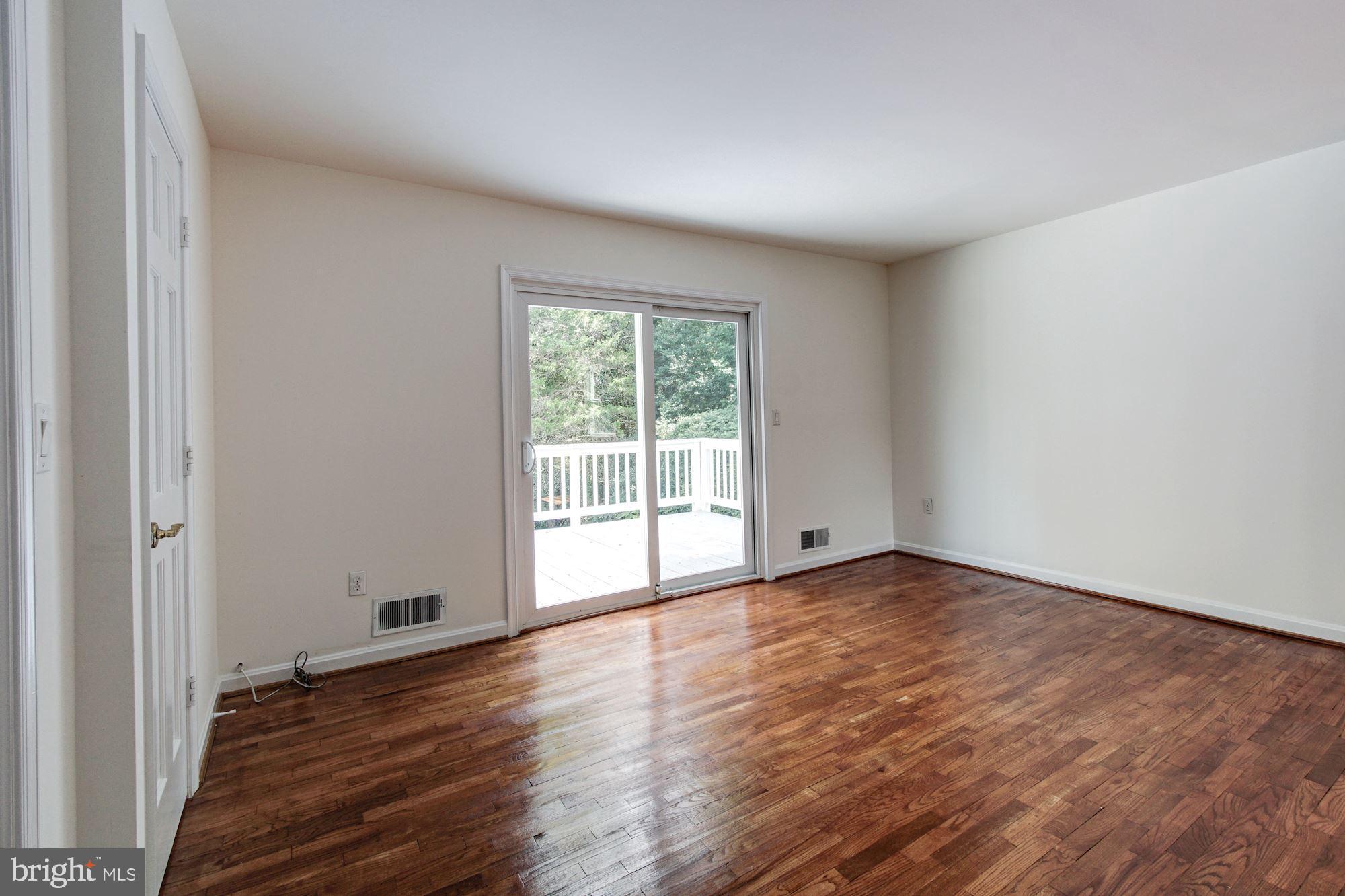 471 Fairhaven Road Tracys Landing, MD 20779 - Photo 15 of 40 a view of an empty room with wooden floor and a window