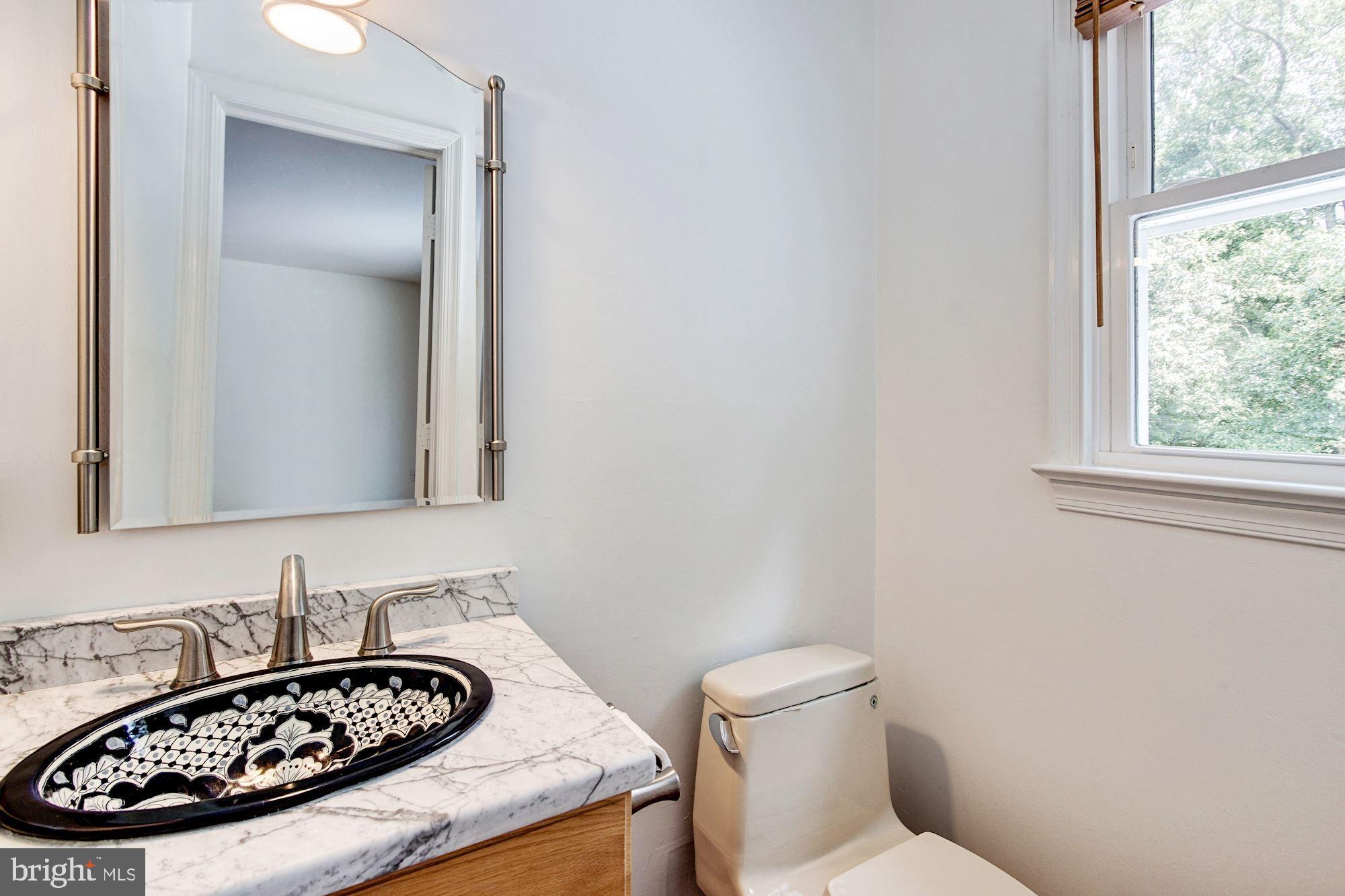 471 Fairhaven Road Tracys Landing, MD 20779 - Photo 18 of 40 a bathroom with a sink a toilet and a mirror