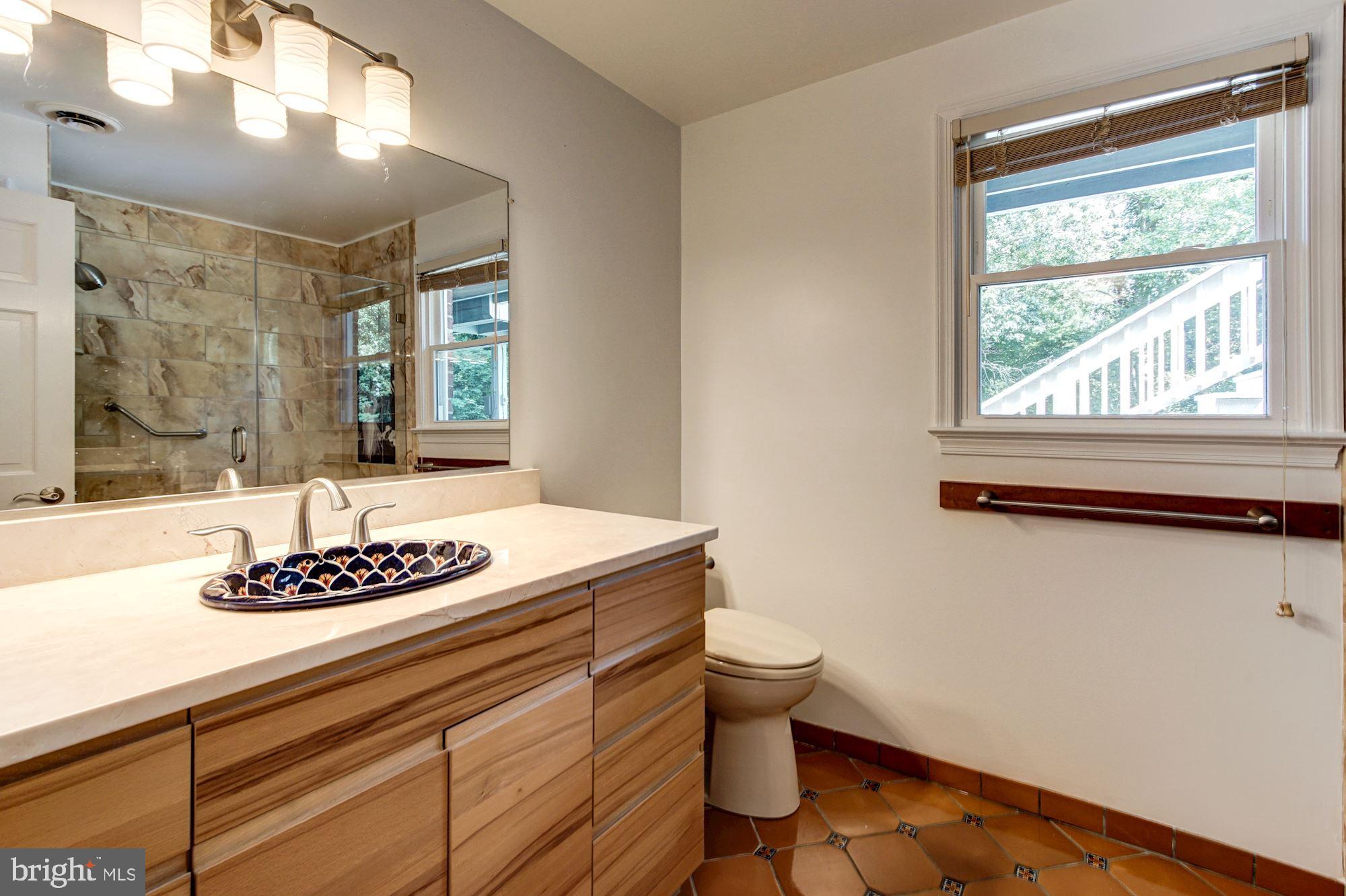 471 Fairhaven Road Tracys Landing, MD 20779 - Photo 24 of 40 a bathroom with a sink a toilet and a window