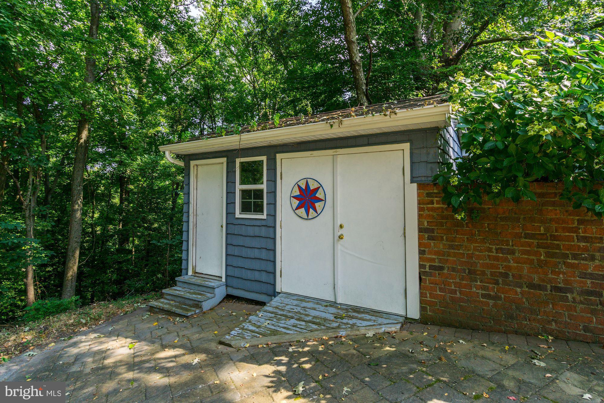 471 Fairhaven Road Tracys Landing, MD 20779 - Photo 37 of 40 a view of a wooden house with a small yard