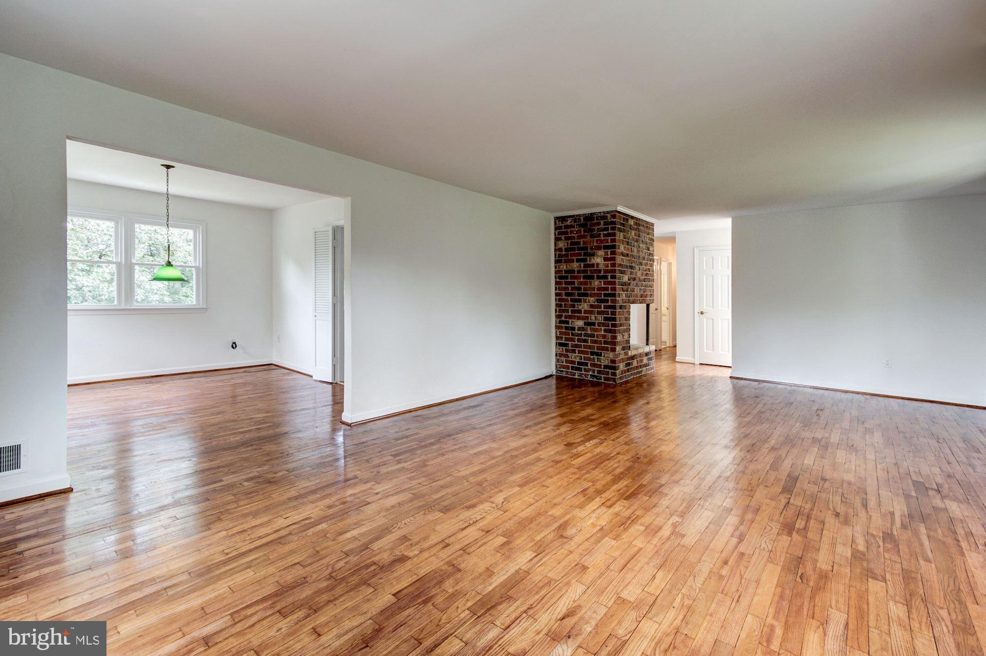 471 Fairhaven Road Tracys Landing, MD 20779 - Photo 5 of 40 an empty room with wooden floor and windows