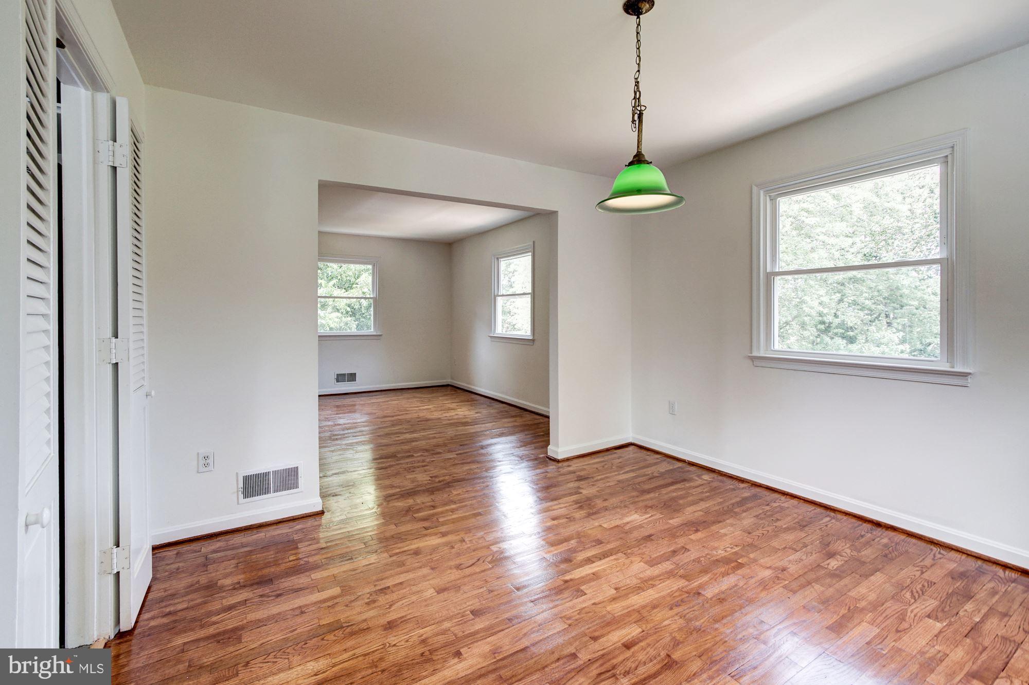 471 Fairhaven Road Tracys Landing, MD 20779 - Photo 7 of 40 a view of an empty room with wooden floor and windows