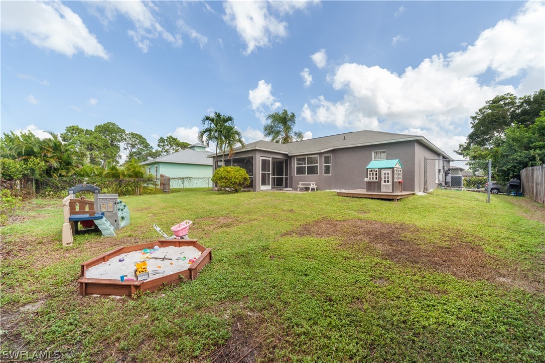 18242 Maple Road Fort Myers, FL 33967 - Photo 23 of 24 a view of a white house with a big yard and large trees