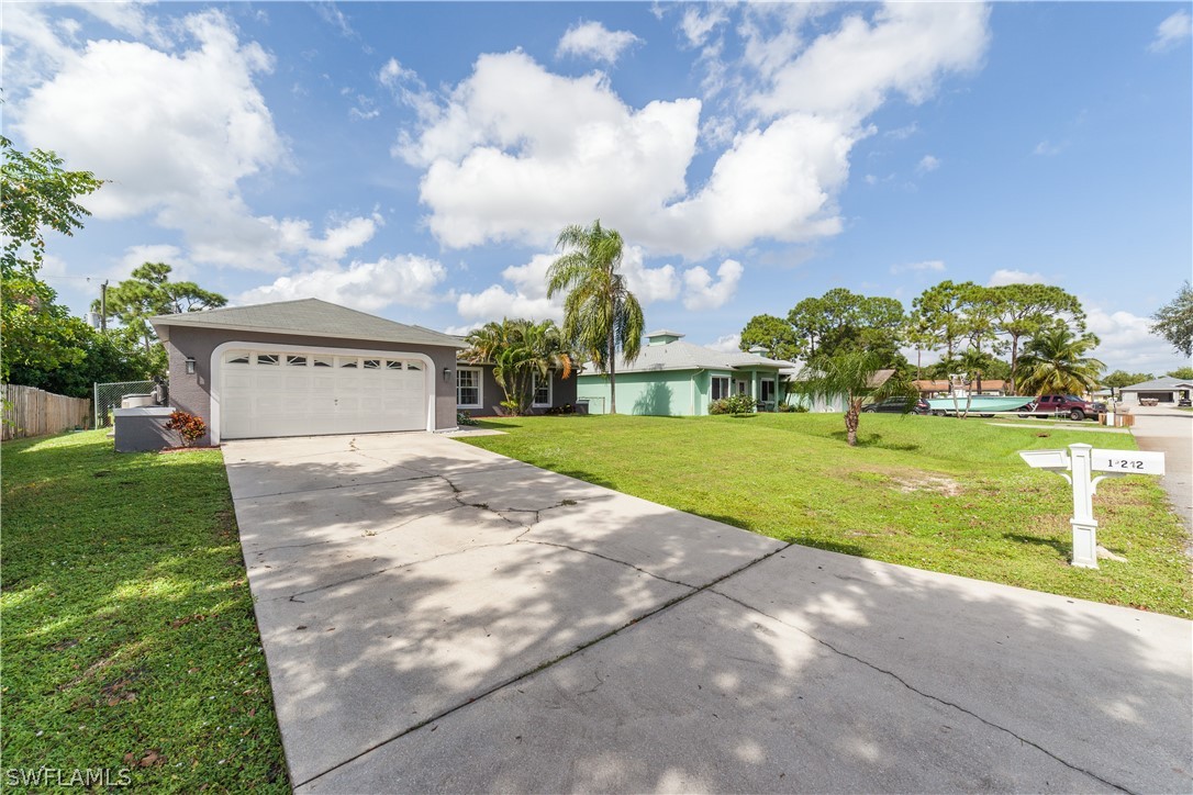18242 Maple Road Fort Myers, FL 33967 - Photo 3 of 24 a view of a house with a yard