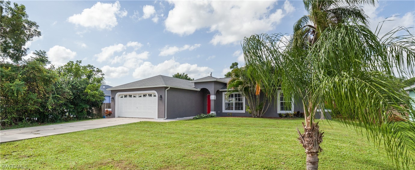 18242 Maple Road Fort Myers, FL 33967 - Photo 4 of 24 a view of a wooden house with a big yard and large trees