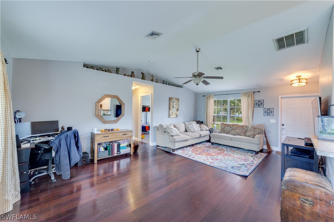 18242 Maple Road Fort Myers, FL 33967 - Photo 7 of 24 a living room with fireplace furniture and a wooden floor