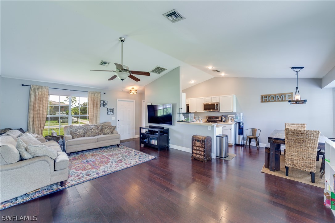 18242 Maple Road Fort Myers, FL 33967 - Photo 8 of 24 a living room with furniture kitchen view and a wooden floor