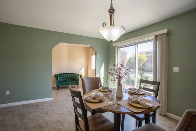a view of a dining room with furniture window and outside view