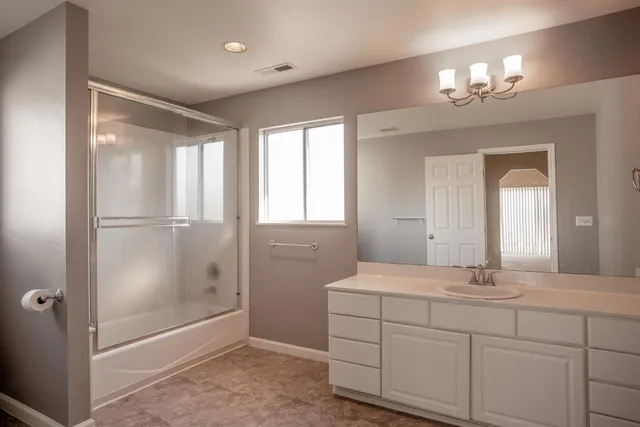 a bathroom with a double vanity sink and a mirror