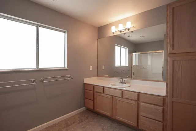 a bathroom with a glass shower door
