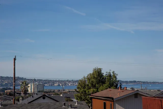 a view of a patio with couches table and chairs and potted plants