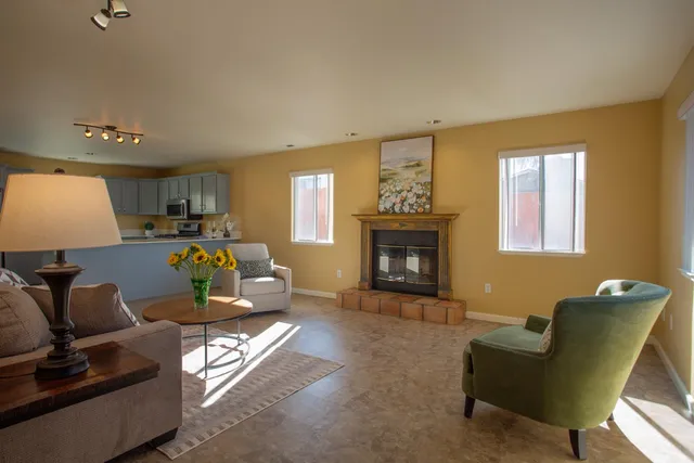 a living room with furniture and a fireplace