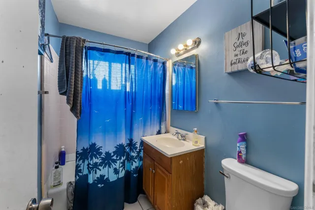 a bedroom with a bed and a potted plant