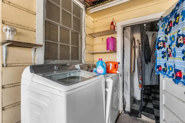 a white toilet sitting next to a bathroom sink and vanity