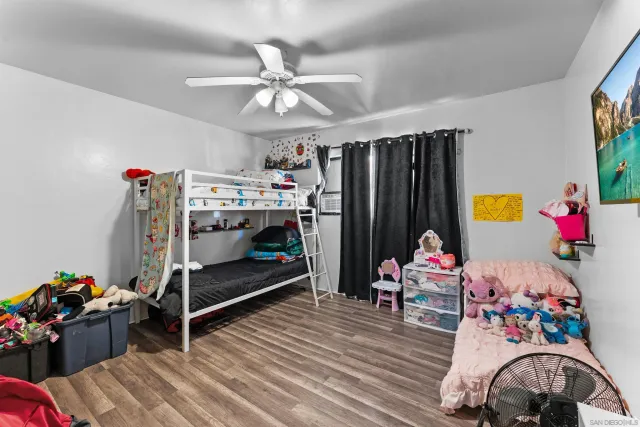 a bedroom with bed and a chandelier