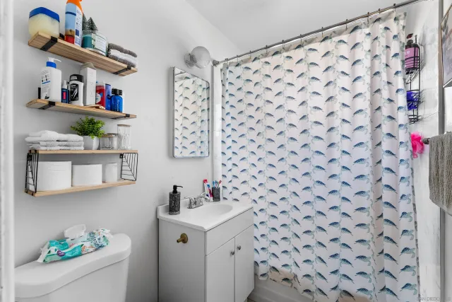 a bathroom with a sink toilet and shower