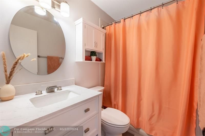 11285 Sunview Way Hollywood, FL 33026 - Photo 20 of 33 a bathroom with a sink a toilet and a mirror