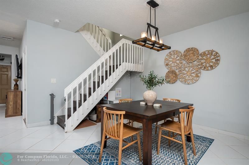 11285 Sunview Way Hollywood, FL 33026 - Photo 9 of 33 a dining room with furniture a chandelier and wooden floor
