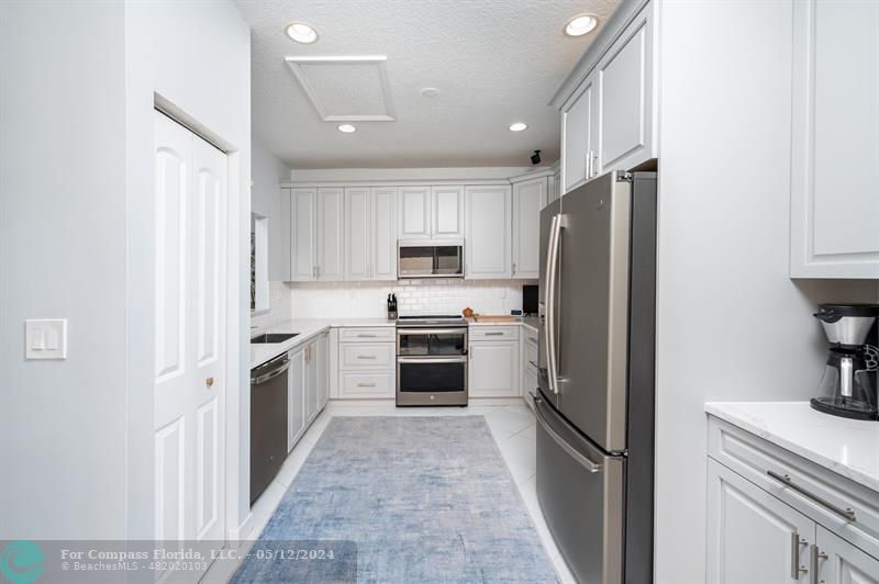 11285 Sunview Way Hollywood, FL 33026 - Photo 10 of 33 a kitchen with cabinets stainless steel appliances and a counter space