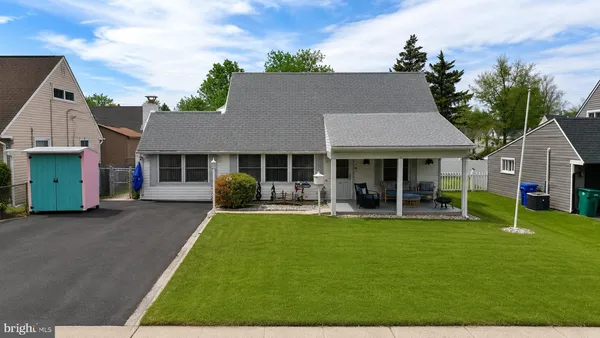 a front view of a house with a yard and green space