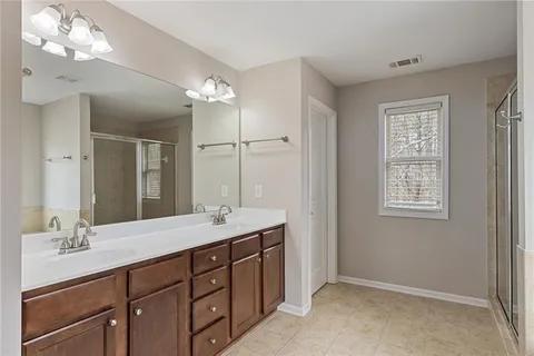 a bathroom with a tub a window and a shower