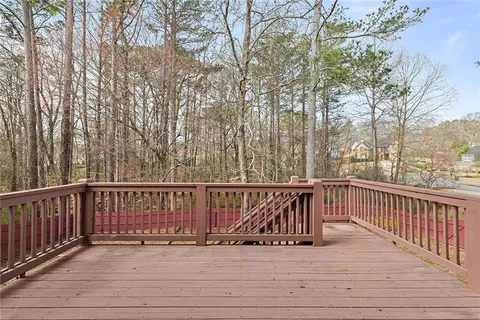 a view of a wooden deck and a backyard