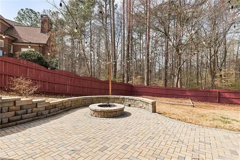 a view of a backyard with wooden fence