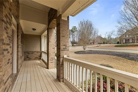 a view of a balcony with furniture and wooden floor