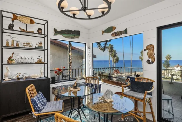 a dining room with furniture and a painting on the wall