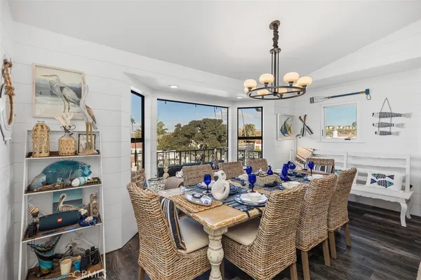 a dining room with furniture a chandelier and window