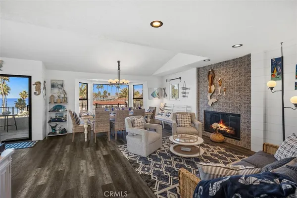 a living room with furniture a fireplace and a chandelier