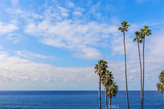 a bedroom with 2 bed and a chandelier