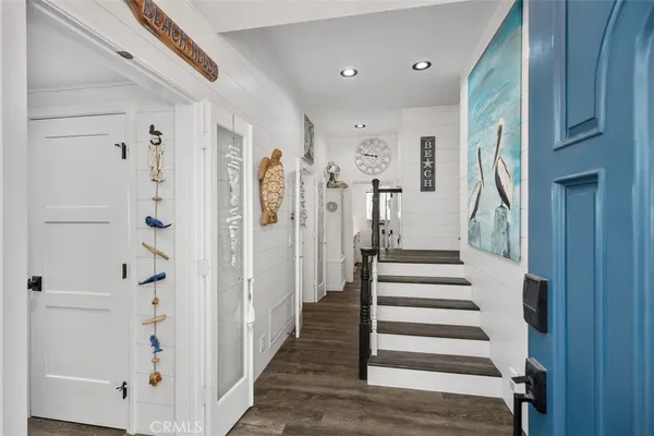a view of entryway with furniture and wooden floor