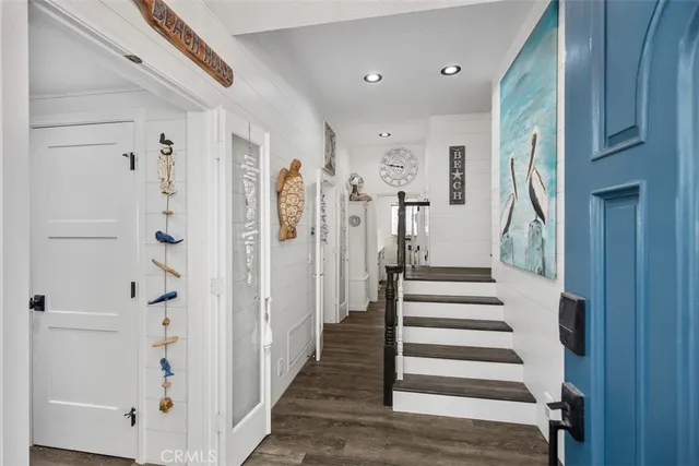 a view of entryway with furniture and wooden floor