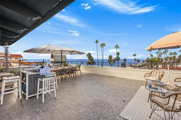 a view of an outdoor space with furniture and umbrella