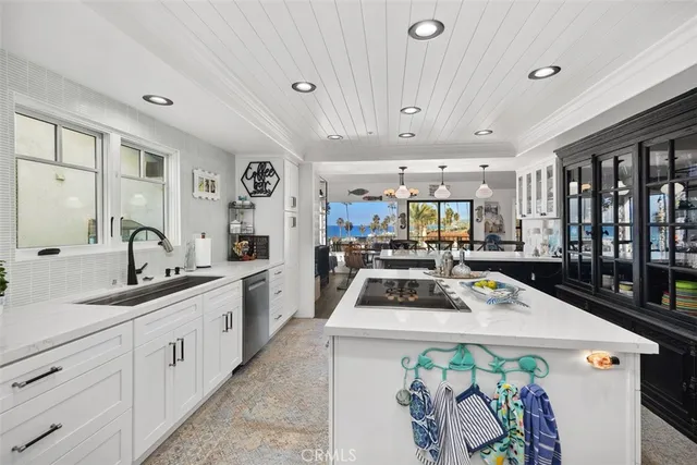 a kitchen with a sink a stove and cabinets